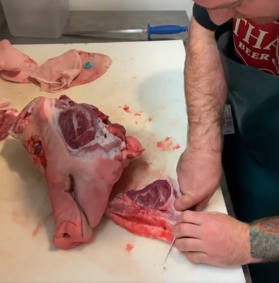 Butchering a pig head