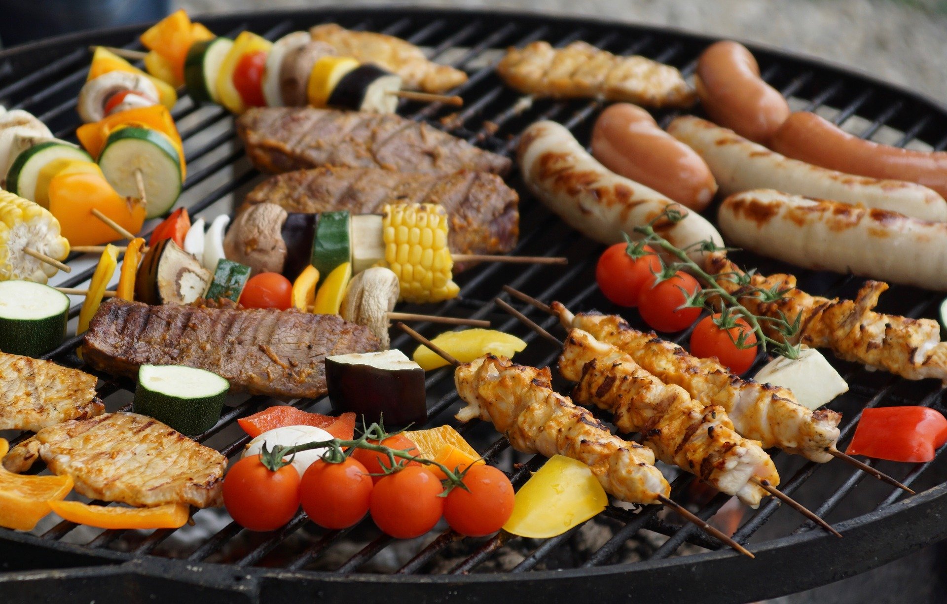 grill filled with meats and vegetables